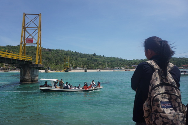 Pelajar pulang dan pergi sekolah kini dengan perahu pasca ambruknya jembatan. Foto: Luh De Suriyani