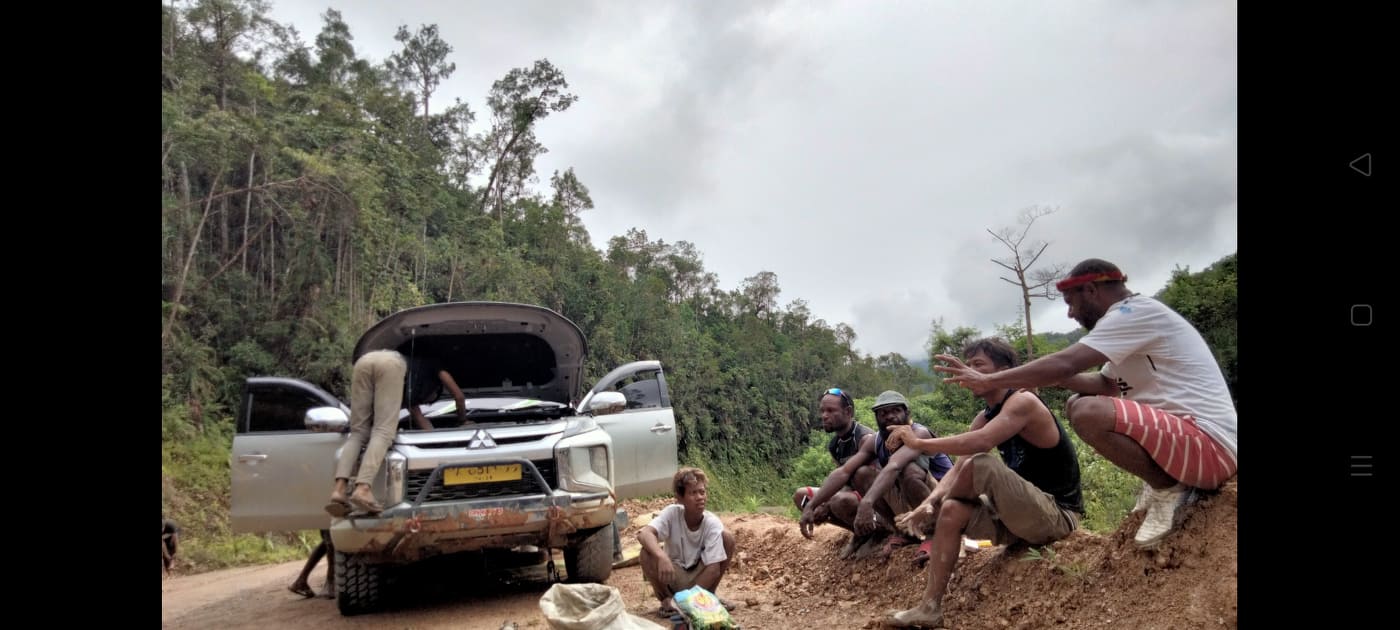 Warga berhenti untuk memperbaiki kendaraan yang rusak. Foto: Gerson Wetapo