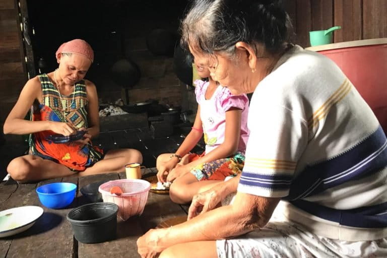 Melepas lelah setelah seharian bekerja di perusahaan sawit. Perempuan Adat Gunung Rantau menikmati sedikit berkat bersama keluarganya foto: meta