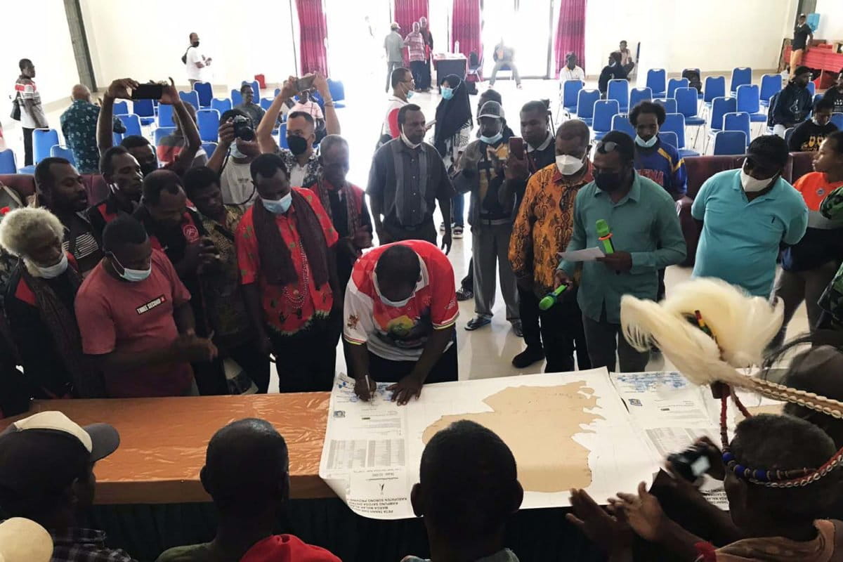 Johny Kamuru, Bupati Sorong, menyerahkan surat keputusan pengakuan hak kepada Masyarakat Adat Gelek Malak Kalawilis Pasa atas tanah dan hutan di Distrik Sayosa, seluas 3.247 hektar, Jumat (15/10/21). Foto: Natalia Yewen/ Mongabay Indonesia