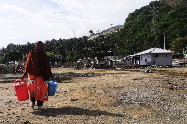 Nana dan termos biru – pinknya. Ikan tak lagi di dapatnya di laut tetapi di pasar. Foto: Rosmini 29/12/21)